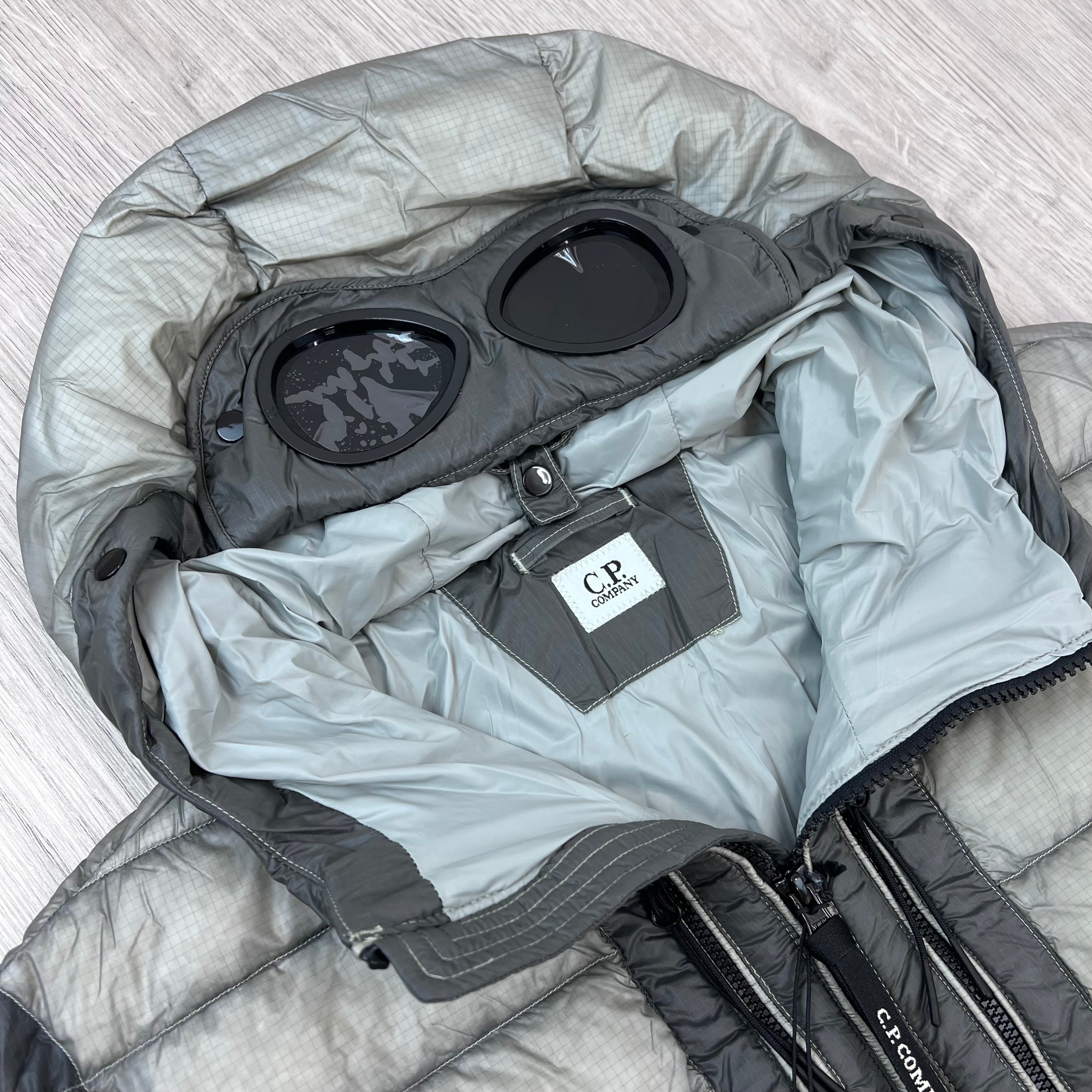 A close up view of the hood and neck label on the CP Company D.D. Shell Goggle Jacket in Flint Grey.