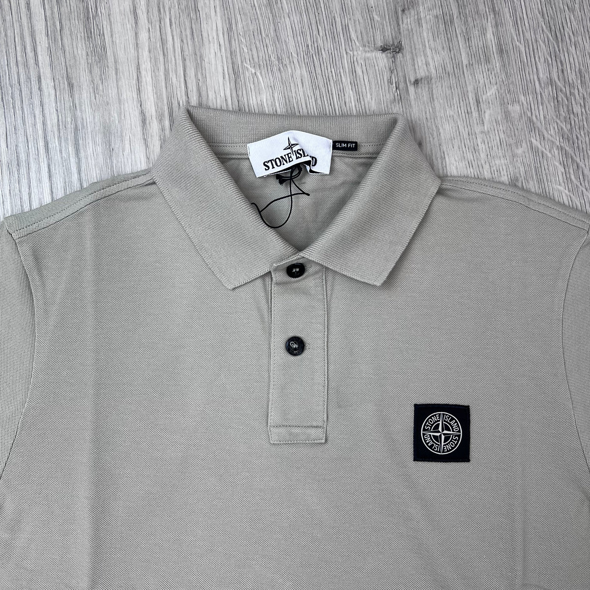 A close up front view of the Stone Island Patch Polo Shirt in Sand.