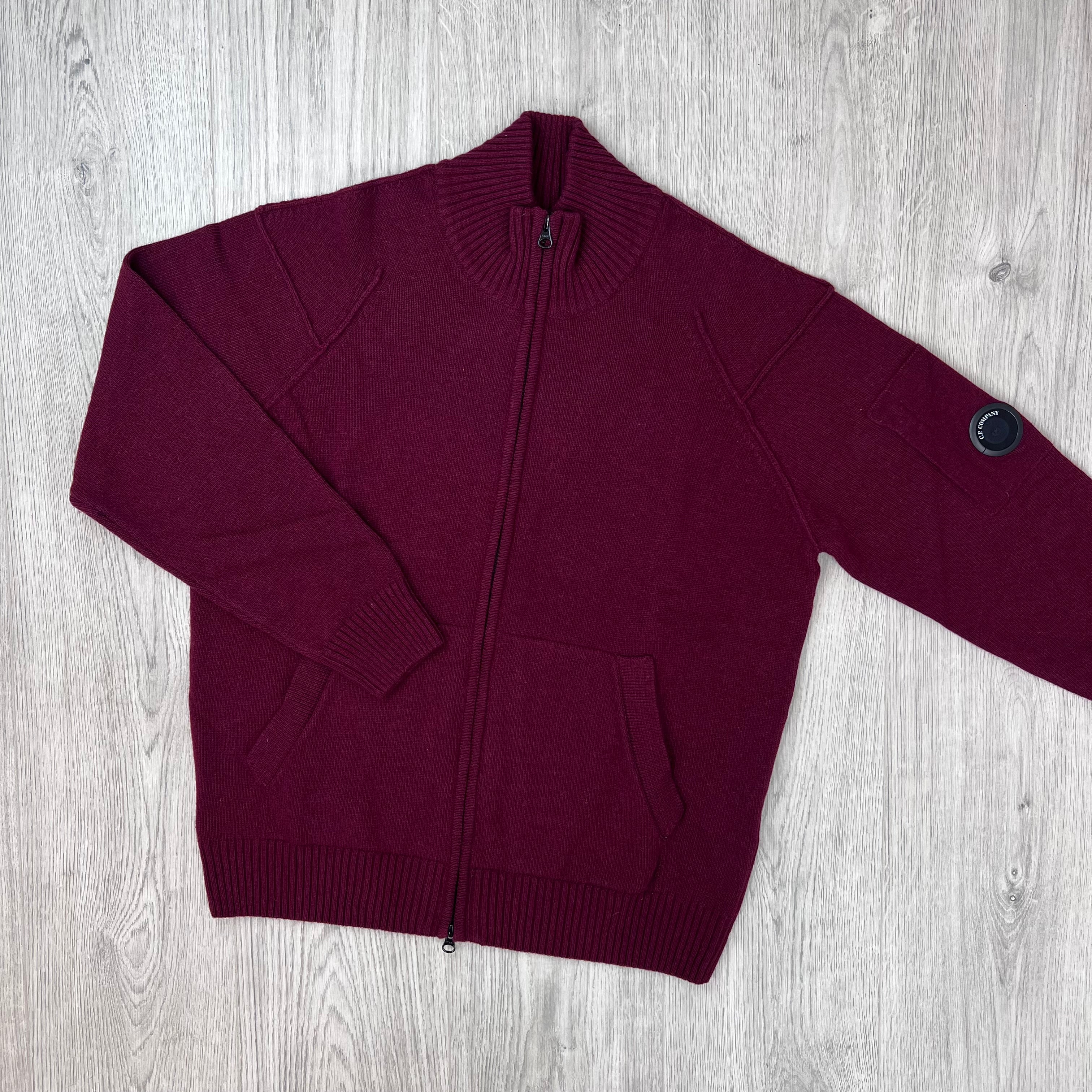 Front image of a CP Company Lambswool Lens Full Zip Sweater in Andorra Red.