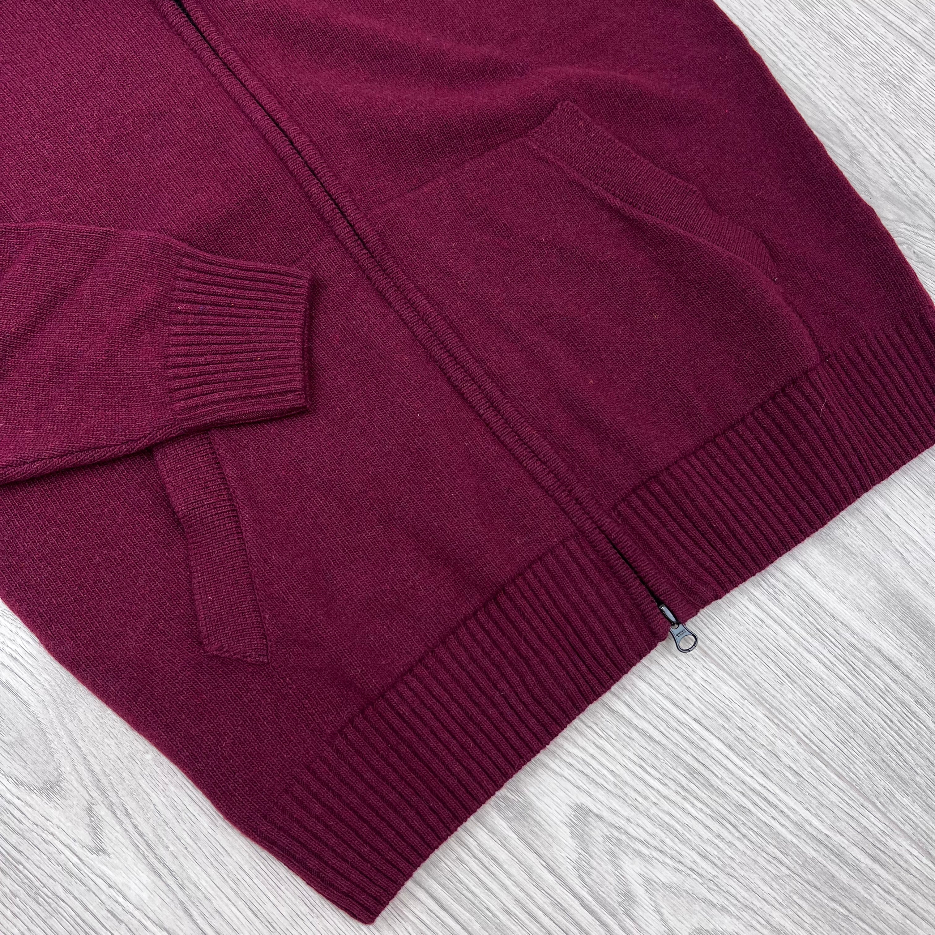 Image of the pockets and cuffs on a CP Company Lambswool Lens Full Zip Sweater in Andorra Red.